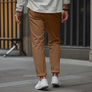 Detailed back view of men's brown slim-fit tapered trousers in an urban setting