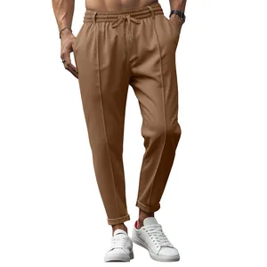 Detailed view of men's brown business casual trousers with elastic drawstring waist.