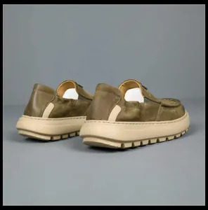 Detailed back view of men's olive green leather loafers featuring durable thick beige soles