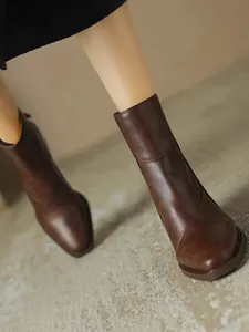 Detailed top-down view showing the premium brown leather texture of vintage ankle boots