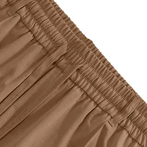 Close-up detail of men's casual trousers featuring elastic waistband and drawstring
