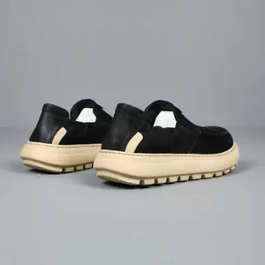 Professional studio shot of men's casual black leather loafers with a soft thick beige sole