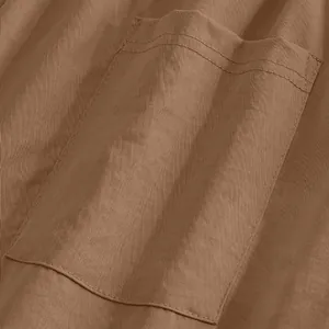 Close-up of double-stitched pocket and fabric texture on men's brown casual trousers.