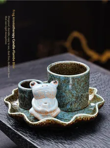 Detail view of the ceramic frog incense burner set with lotus leaf tray in flambe blue