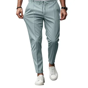 Detail of men's slim fit drawstring trousers in light blue-grey showing fabric elasticity.
