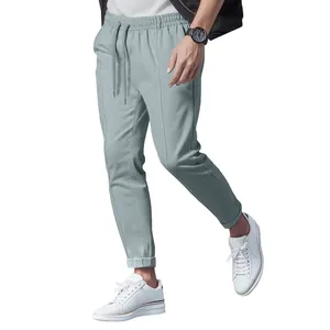 Men's sage green drawstring casual pants slim fit tapered joggers with white sneakers