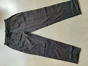 High-angle view of men's charcoal grey casual business trousers featuring a drawstring waist.