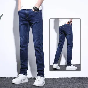Detail view of men's dark blue slim fit stretch straight leg denim jeans showing front and back