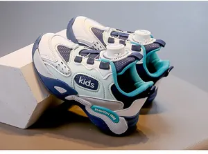 Detail view of breathable mesh kids sneakers featuring a rotary dial lacing system.