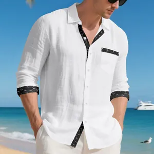 Detail of white linen long sleeve shirt with black bird print trim on beach background