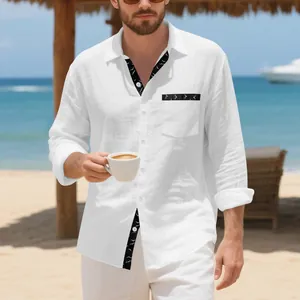 Detail of men's white linen long-sleeve shirt with bird print accents at a beach resort.