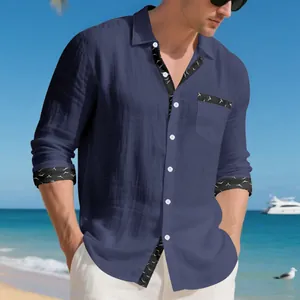 Detail view of navy blue linen shirt with bird print on cuffs and collar.