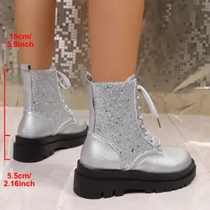 Detail of silver glitter Martin boots featuring a 5.5cm platform and 15cm shaft height.