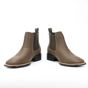 Detailed view of brown ostrich texture Chelsea boots for men with western stitching