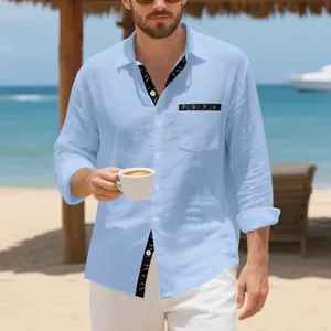 Casual man wearing a light blue linen long sleeve shirt with printed trim at the beach