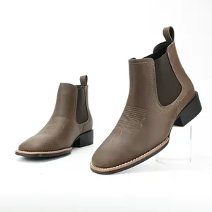 Side profile detail of brown Chelsea boots with decorative western stitching patterns
