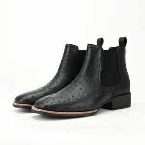 Side profile view of black ostrich texture Chelsea boots showing chunky low heel
