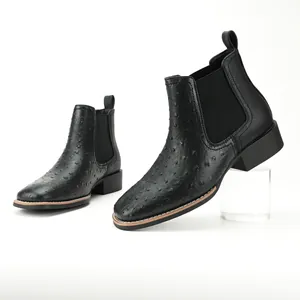 Detailed side view of black ostrich pattern men's Chelsea boots with a sturdy block heel