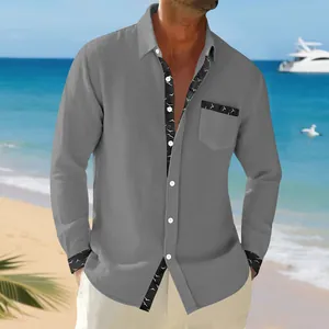 Detail of men's grey linen long-sleeve shirt with stylish bird print trim on cuffs.