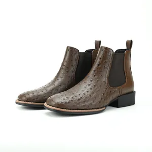 Detailed view of brown ostrich-textured Chelsea boots with block heel and retro style