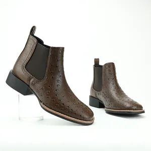 Detailed macro view of ostrich texture on brown men's Chelsea boots with chunky heels