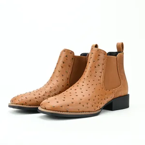Close-up detail of tan ostrich-patterned Chelsea boots with elastic side panels