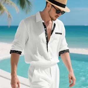 Detail of men's white linen shirt with black patterned trim and pocket in resort style.