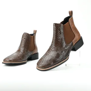 Close-up of brown ostrich pattern Chelsea boots showing side elastic panel and heel texture