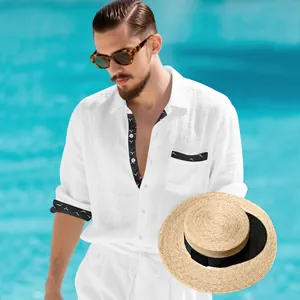 Detail view of men's white linen long-sleeved shirt featuring black patterned trim