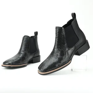 Close-up of black ostrich pattern men's Chelsea boots with retro British style.