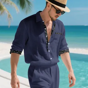 Detail view of navy blue linen resort shirt with patterned trim on a model by the pool