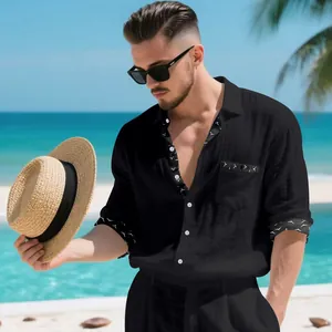 Close-up view of men's black linen shirt with contrast trim and front chest pocket