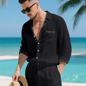 Stylish man wearing black linen casual shirt with patterned trim at a tropical beach resort