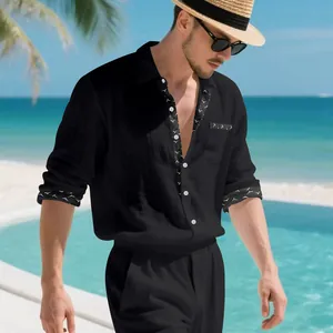 Detail of black linen resort shirt with white bird print contrast trim and pocket