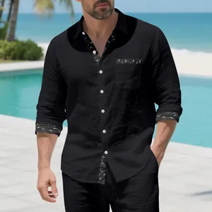 Detail shot of men's black linen casual shirt with patterned bird print cuffs and trim