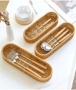 Detail view of woven cutlery baskets holding wooden handled forks and spoons