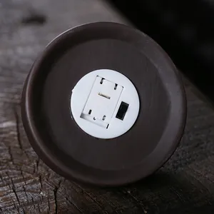 Macro close-up view of a purple sand backflow incense burner base featuring LED light switch