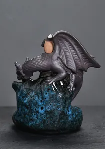 Detailed view of ceramic backflow incense burner with dragon perched on blue glazed rock