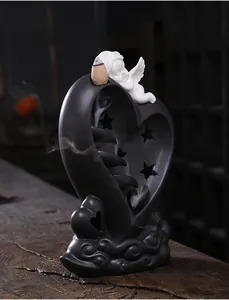 Backflow incense burner featuring a ceramic heart and cupid with flowing smoke detail