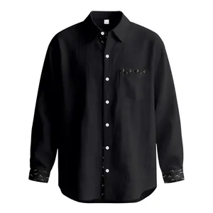 Detailed view of black men's linen long sleeve shirt with unique patterned trim accents.