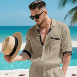 Men's khaki linen vacation shirt with patterned trim in a tropical beach setting