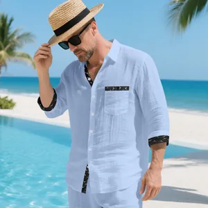 Casual light blue linen shirt with contrast bird print trim in beach setting