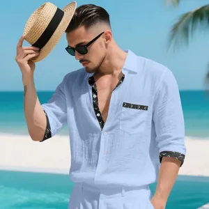 Men's light blue linen shirt with patterned trim detail for casual beach vacation.