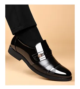 Detailed macro view of black patent leather men's dress shoes with stylish side buckle
