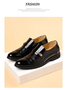 Detailed close-up view of shiny black patent leather men's dress shoes on a white platform