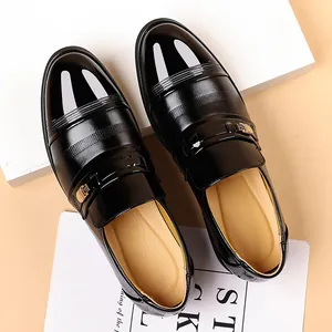 Men's glossy black leather dress shoes with gold buckle and striped texture for formal wear