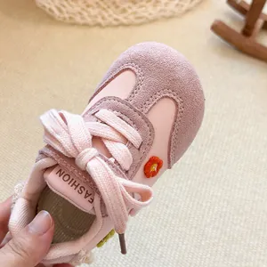 Close-up detail of pink toddler girl sneakers with mesh fabric and flower embroidery