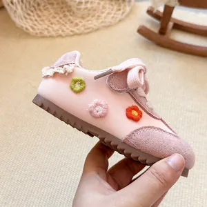 Side view of pink toddler girls' sneaker with embroidered flowers and soft sole