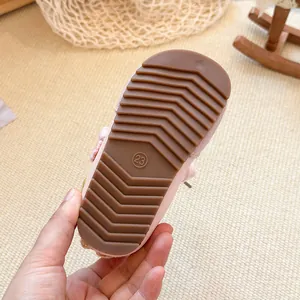 Detailed view showing the brown non-slip rubber outsole of a pink breathable baby girl shoe