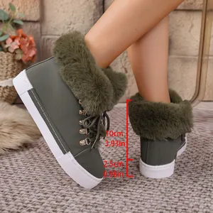 Detail view of green women's snow boots with faux fur trim and height measurements
